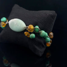 Загрузить изображение в средство просмотра галереи, A bracelet with a green chrysoprase centerpiece and multicolored jasper beads, displayed against a black background.