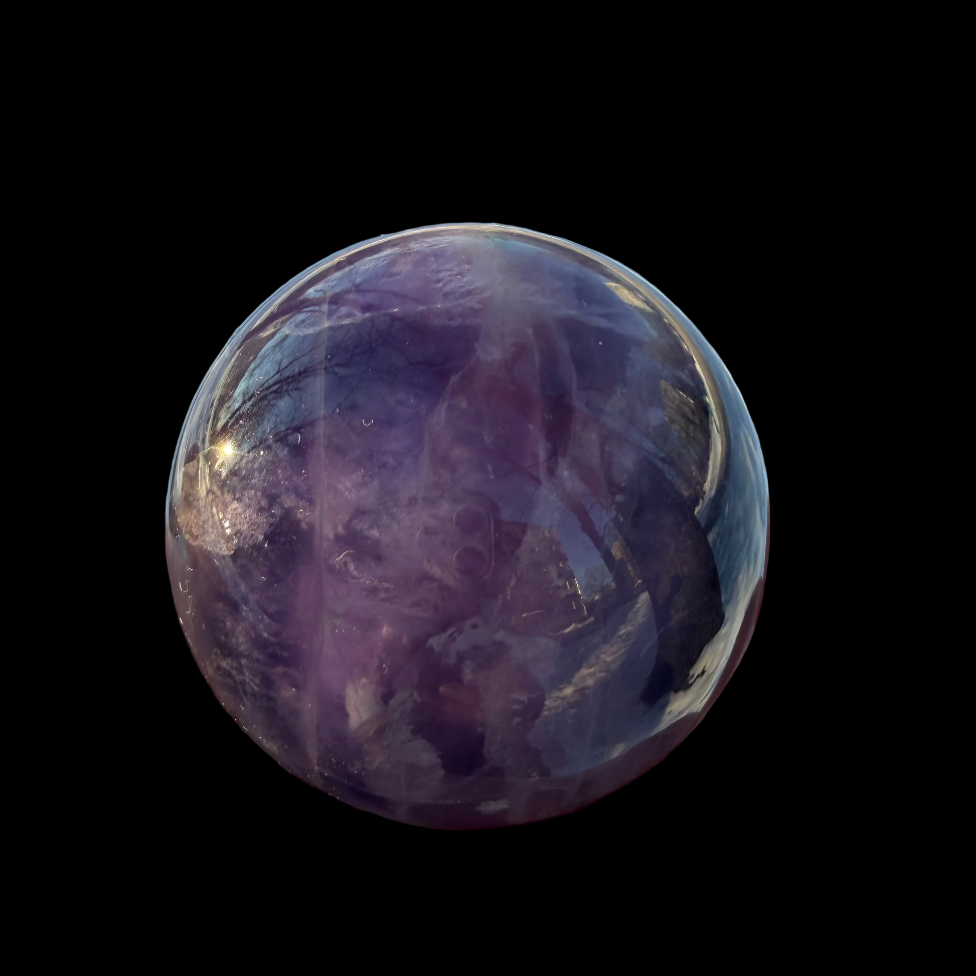 Fluorite Sphere 360 g 60 mm. Purple crystal ball with reflections on a black background