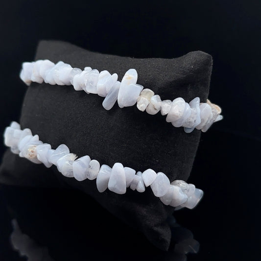 A two-strand bracelet made of blue chipped agate stones, displayed against a black background.