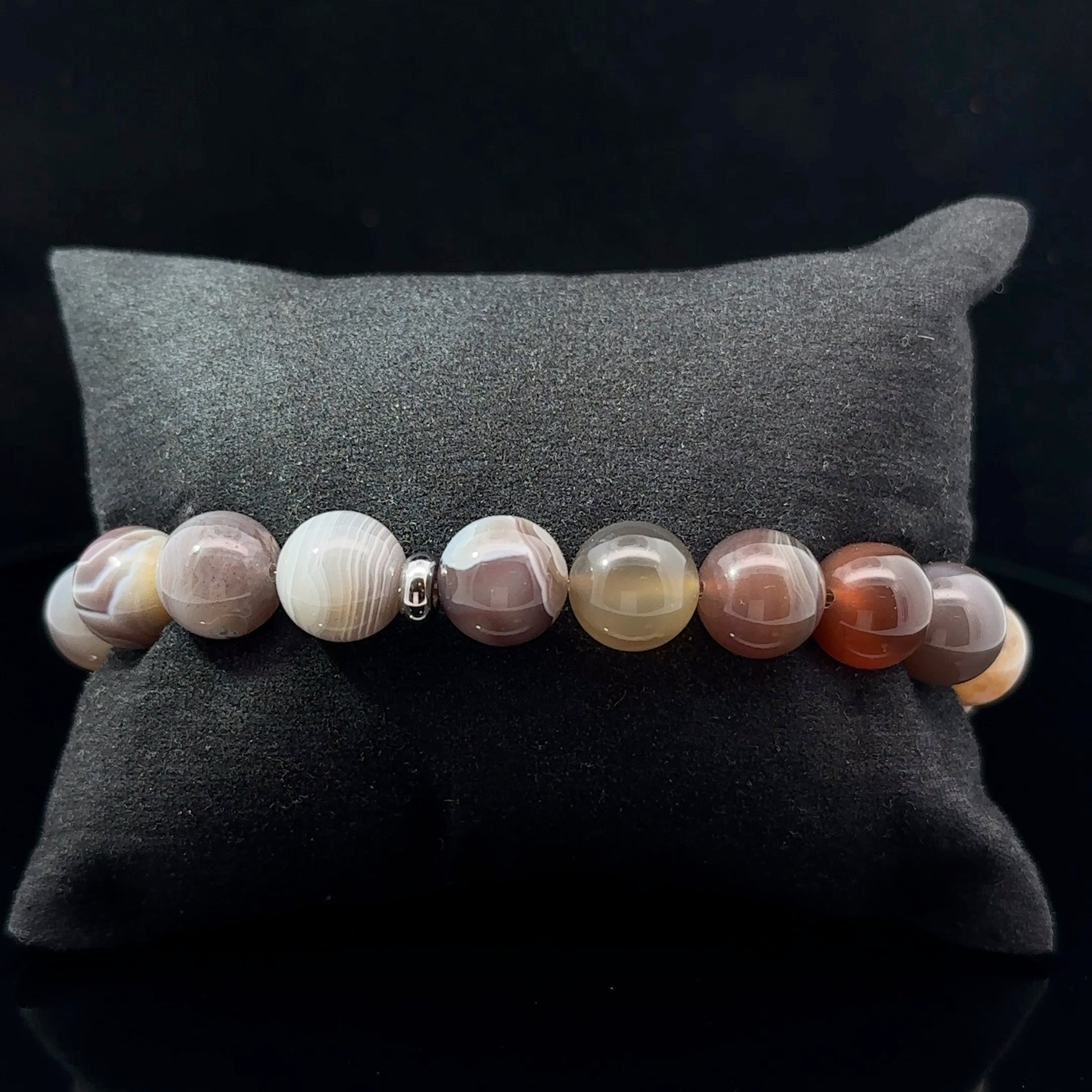A multicolored agate bead bracelet with varying shades of gray, beige, and brown.
