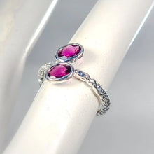 Load image into Gallery viewer, Silver ring with two pink gemstones on a white stand
