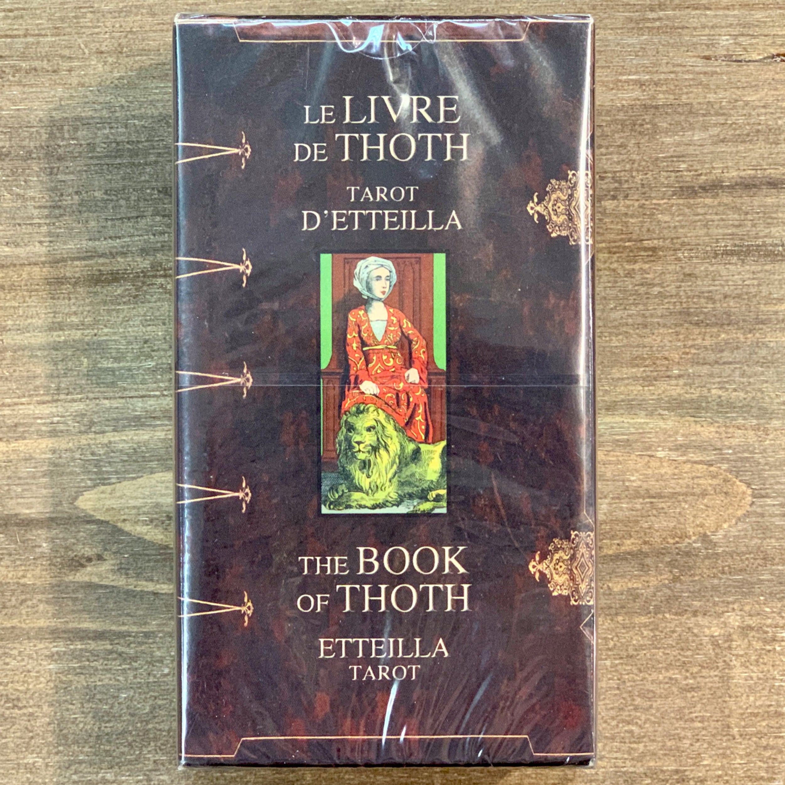Box of the Book of Thoth Etteilla Tarot deck, showing the title in French and English with a central image of a seated woman and a lion, symbolising its esoteric design.